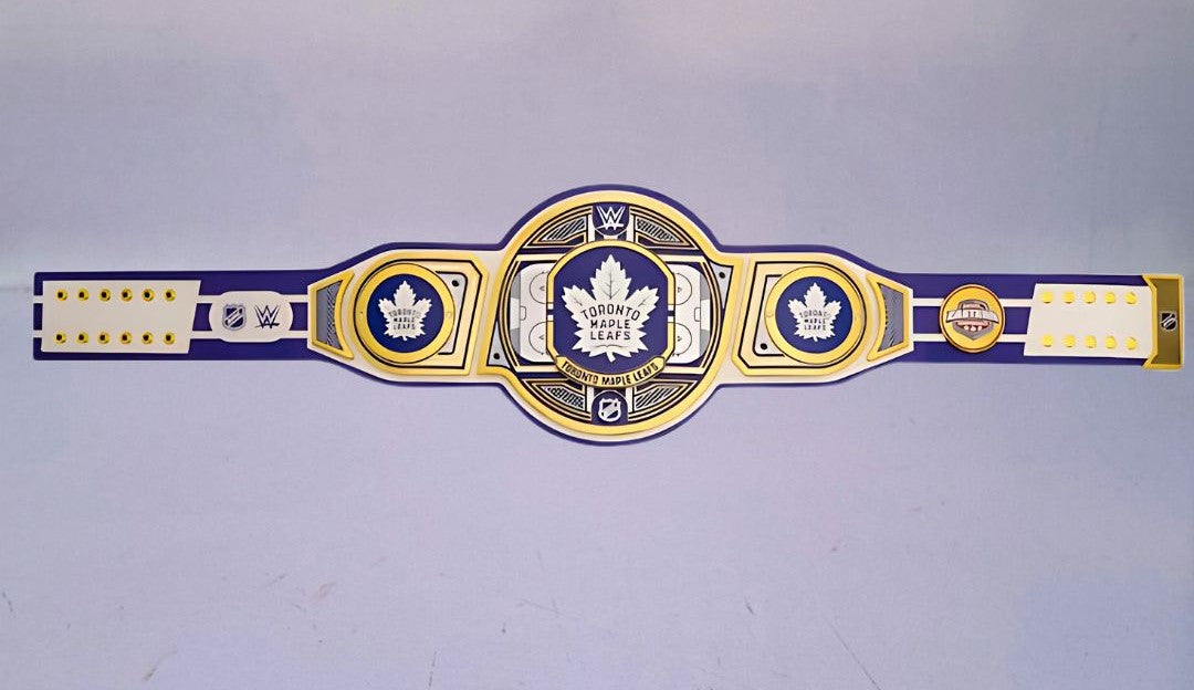 Detailed view of the WWE Championship Belt for the Toronto Maple Leafs, featuring embossed logos and a polished finish.